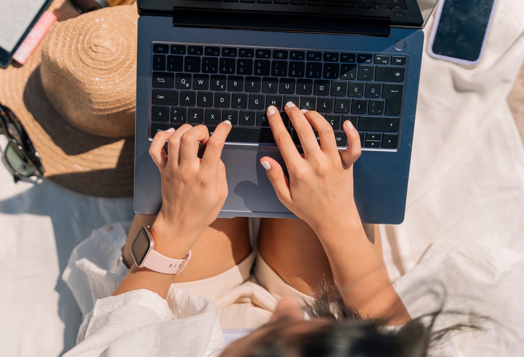 Woman with Laptop Working at the Beach